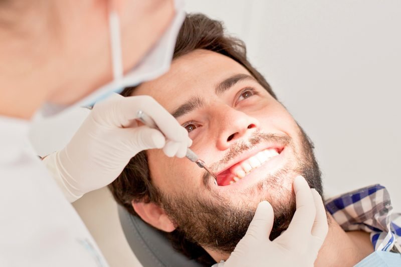 young man and woman in a dental examination at dentist